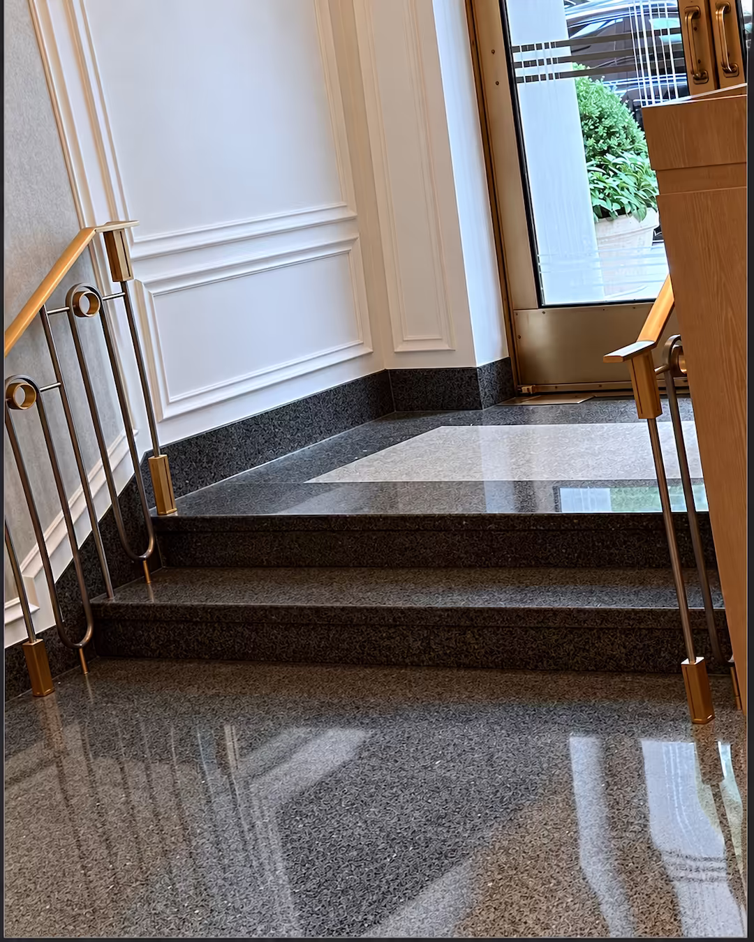 Finished Shore Towers residential lobby with custom epoxy terrazzo flooring and leather seating overlooking the waterfront.