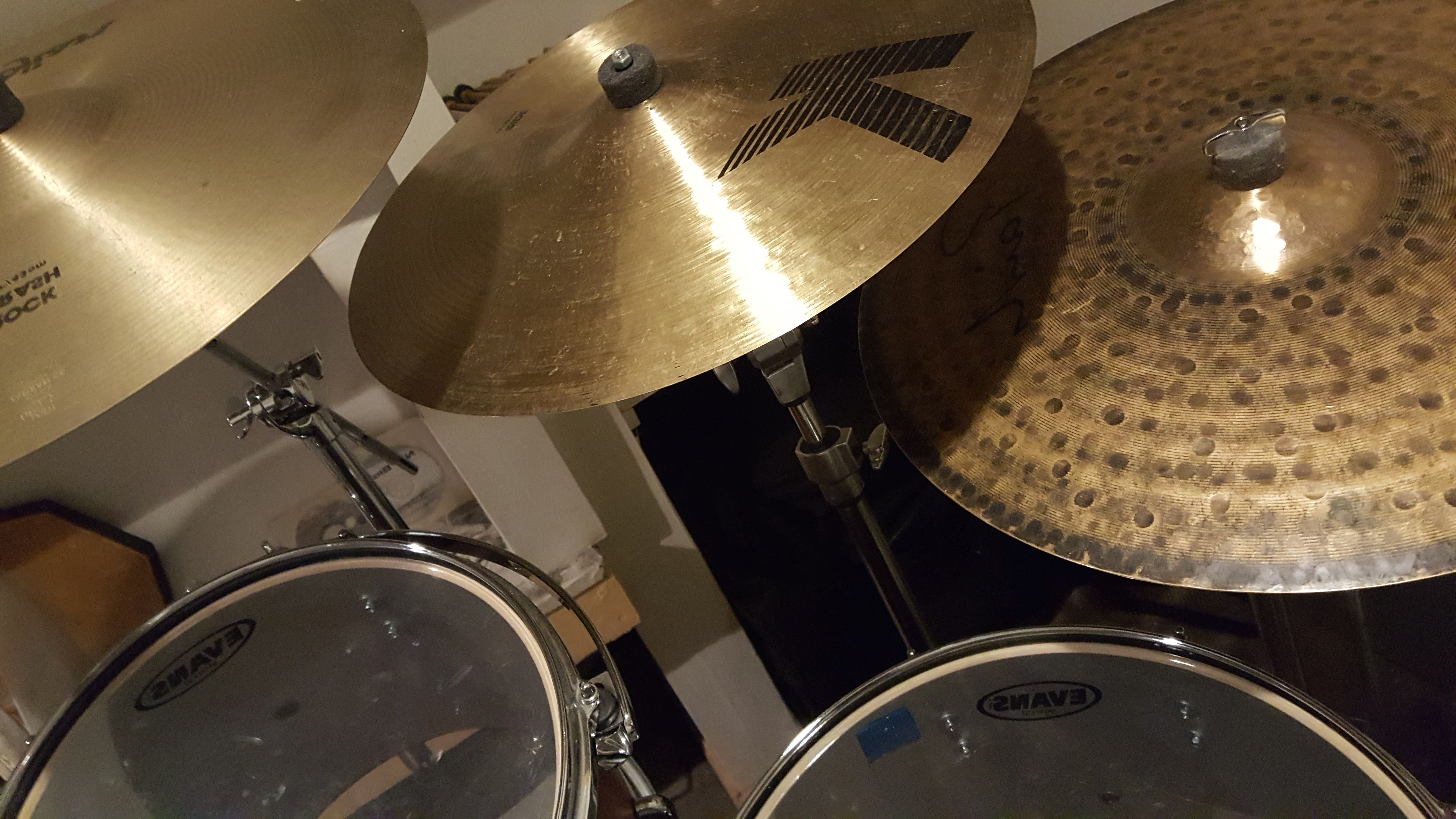 Close view across an acoustic drum kit with multiple cymbals and toms