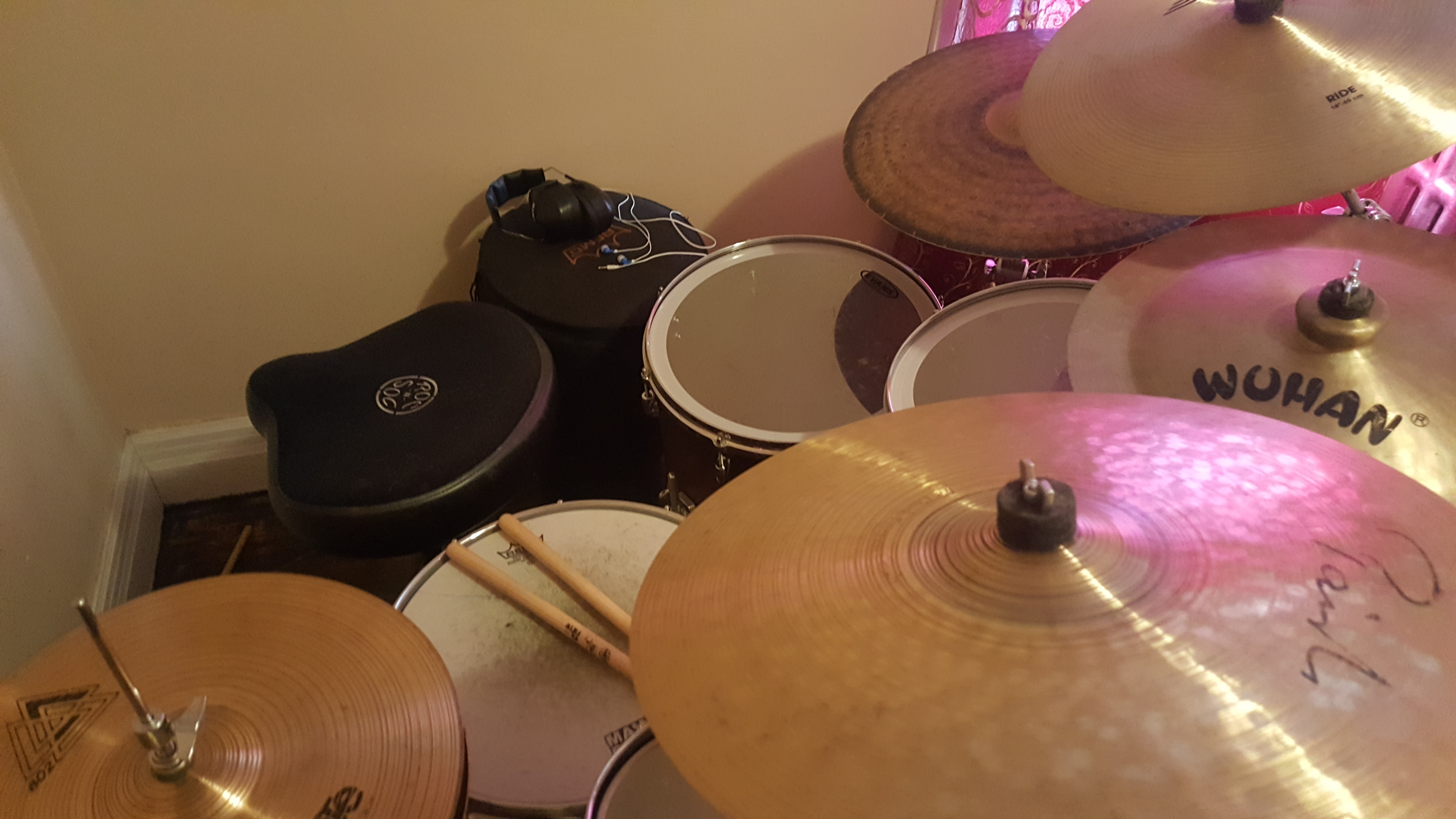 Player's view across an acoustic drum kit with cymbals, toms, and snare