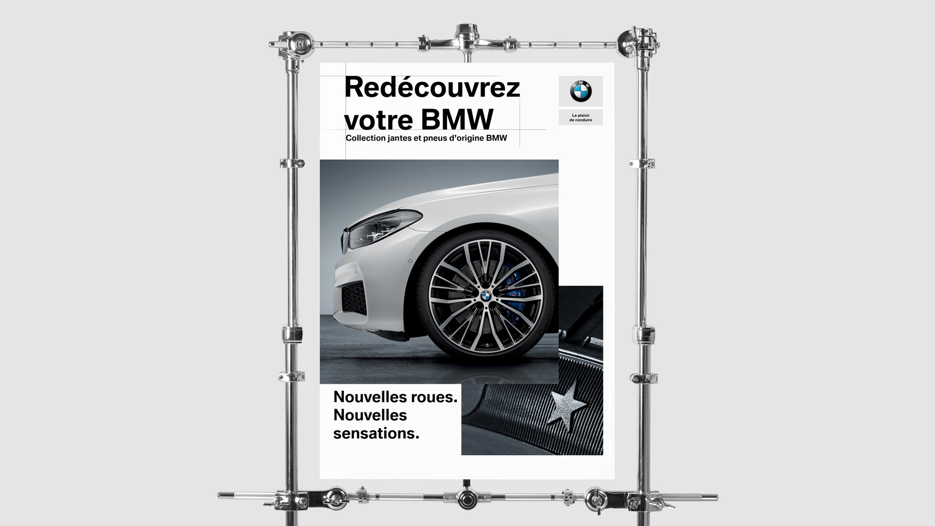 BMW, affiche « Redécouvrez votre BMW » : l’avant d’une BMW blanche et sa jante, « Nouvelles roues. Nouvelles sensations. »