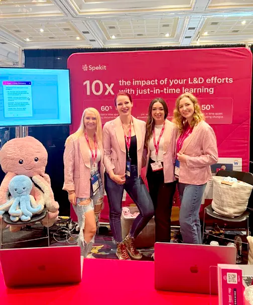 Four Spekit employees working a booth