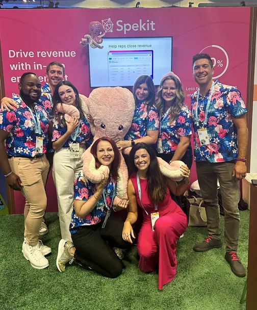 Spekit team wearing Hawaiian themed shirts at a booth