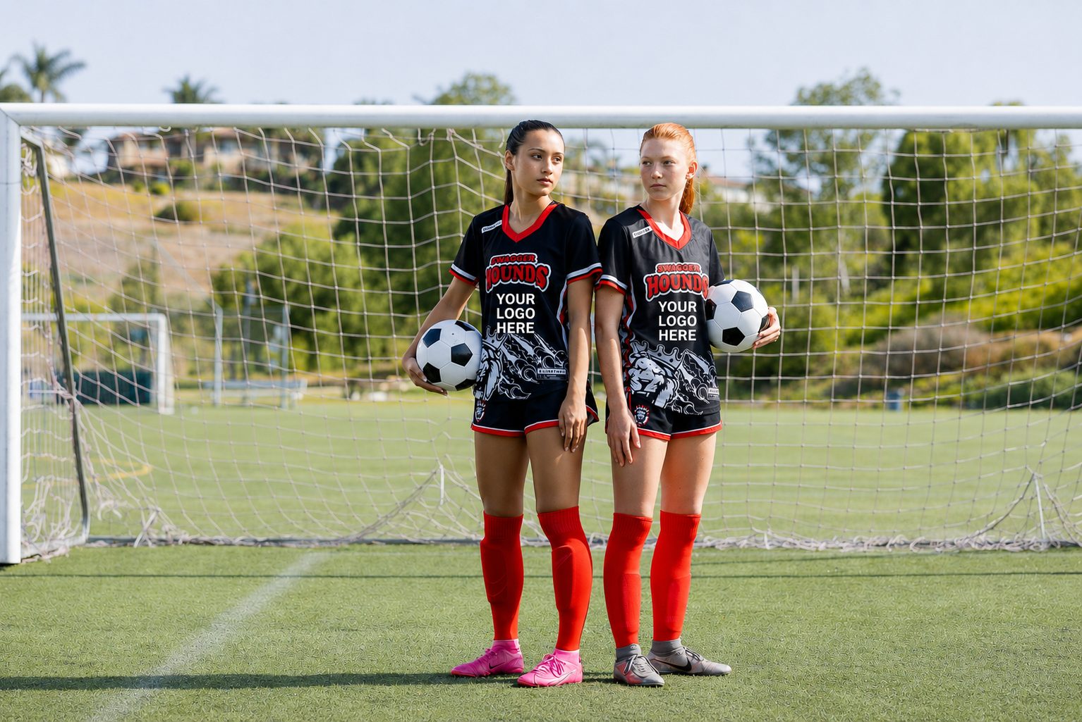 Two youth soccer players in jerseys with a sponsor logo placement on the chest