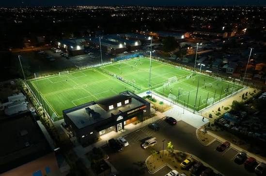 Lit youth soccer facility at night