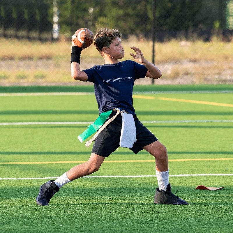 Young flag football quarterback throwing a pass