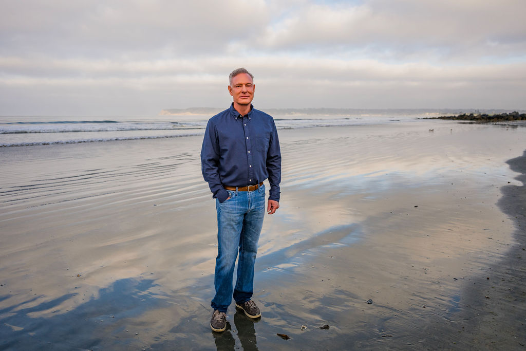 Scott Peters standing on the San Diego shoreline at low tide