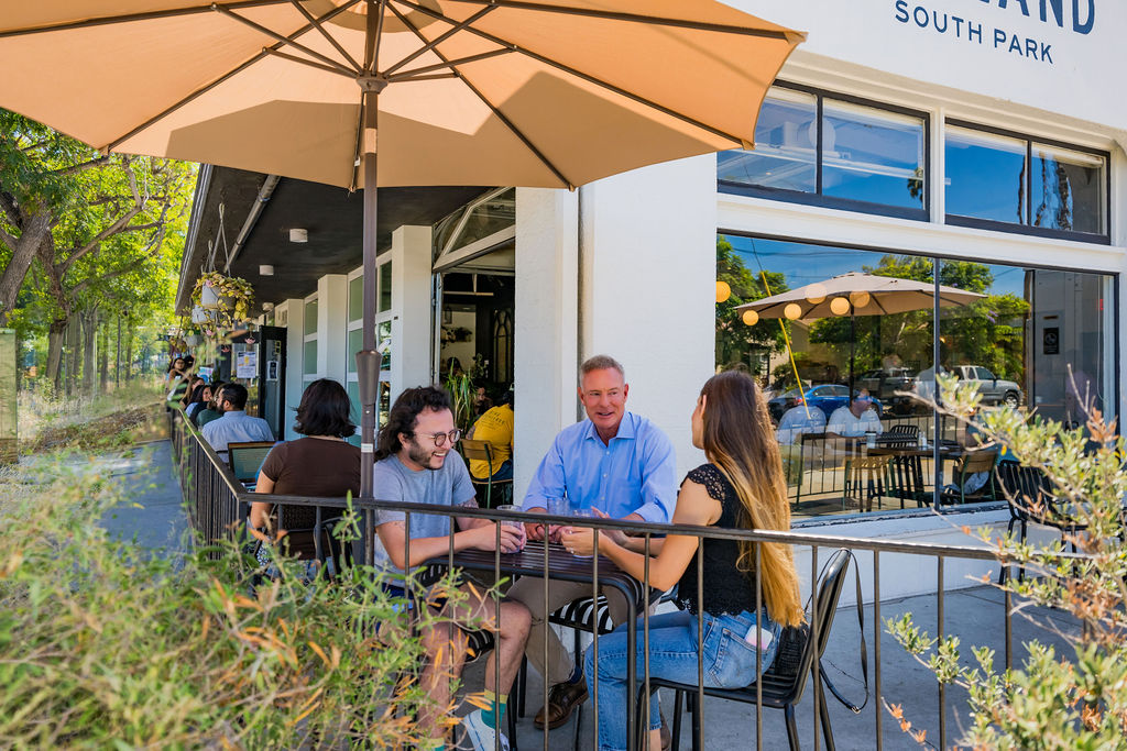 Scott Peters talking with San Diegans on a South Park café patio