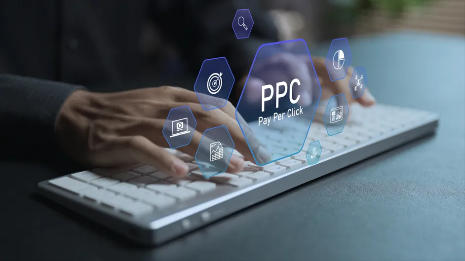 Hands on a keyboard under a pay-per-click graphic.