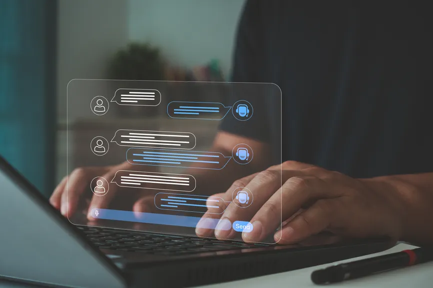 Laptop with chat message graphics floating above the keyboard.