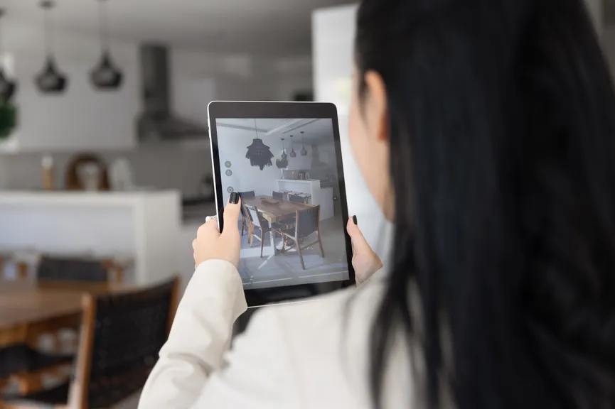 Person photographing a room with a tablet.