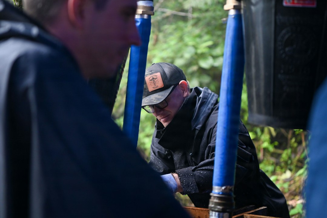 plumbing technician using a hydro-jetting machine to clean a main sewer line - how professional drain cleaning differs from