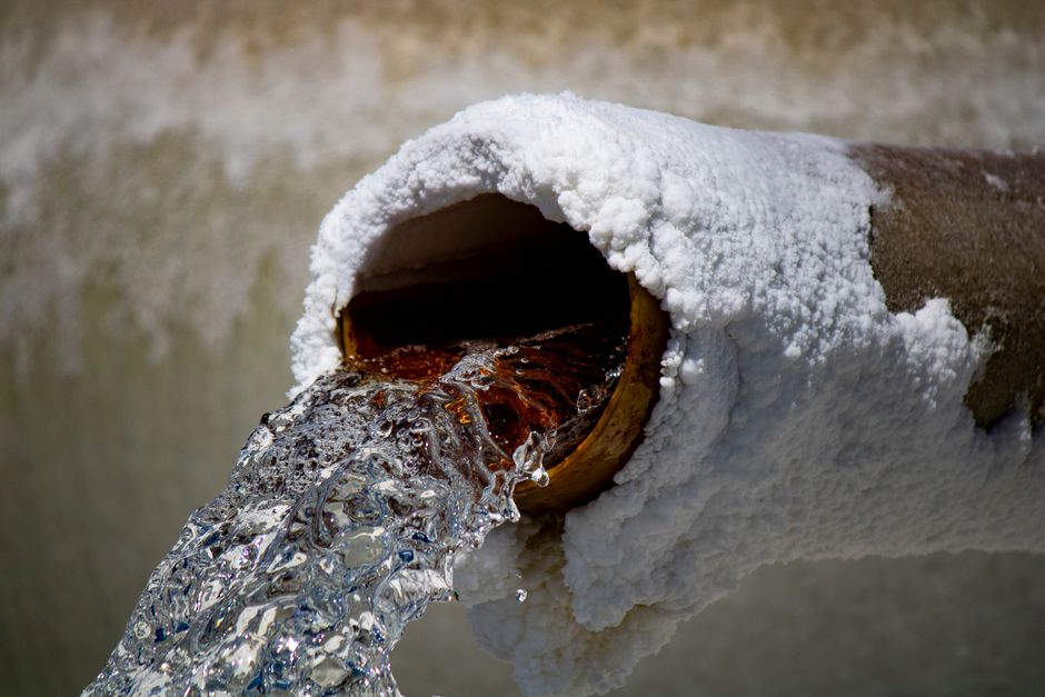 corroded galvanized steel pipes with mineral buildup restricting water flow - plumber for low water pressure