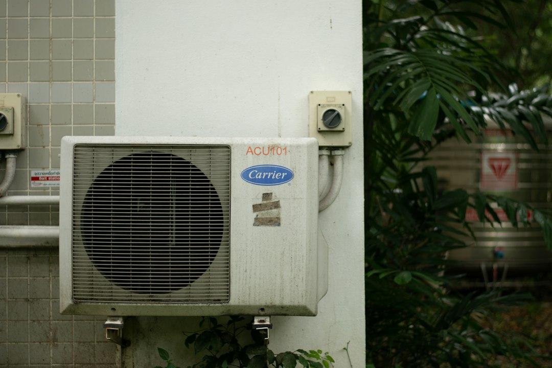 outdoor condenser unit for a central air conditioning system sitting on a concrete pad - central ac vs ductless mini split
