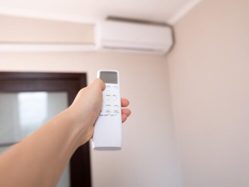 Hand holding AC remote control