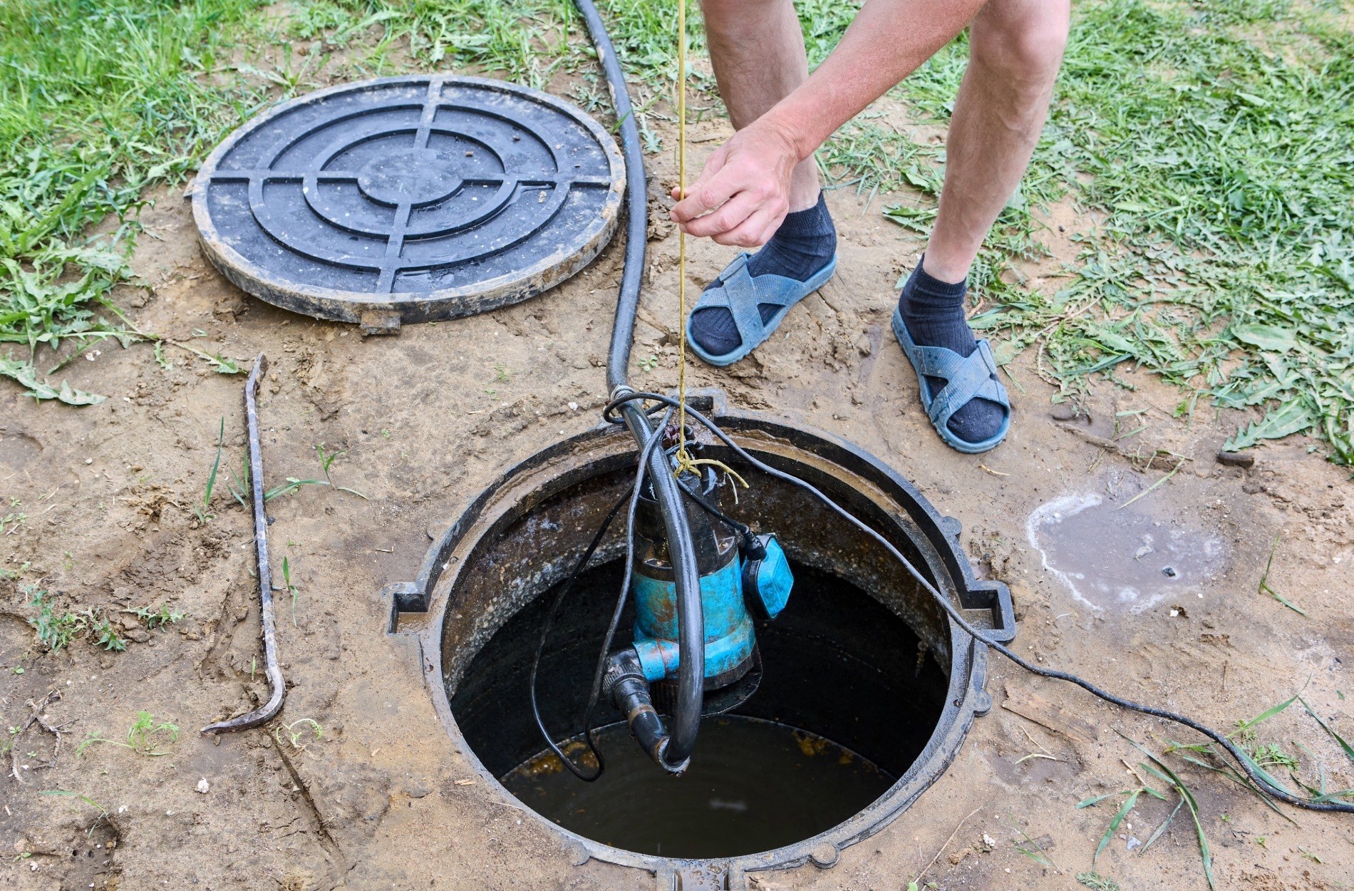 Person servicing outdoor sump pump
