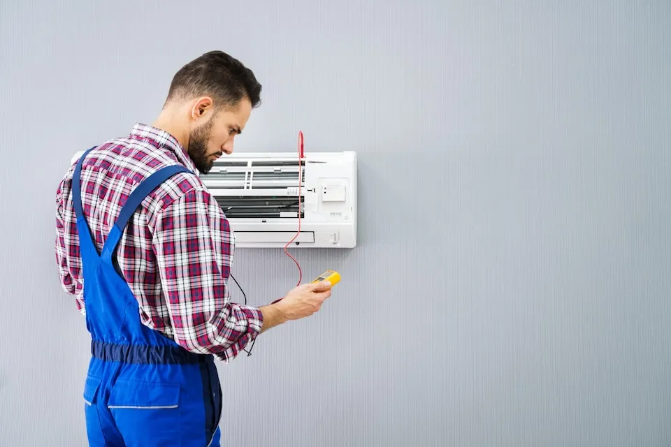 Technician checking AC unit