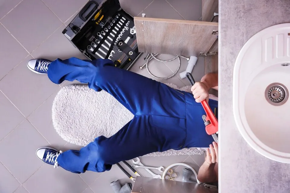 A plumber fixing a sink