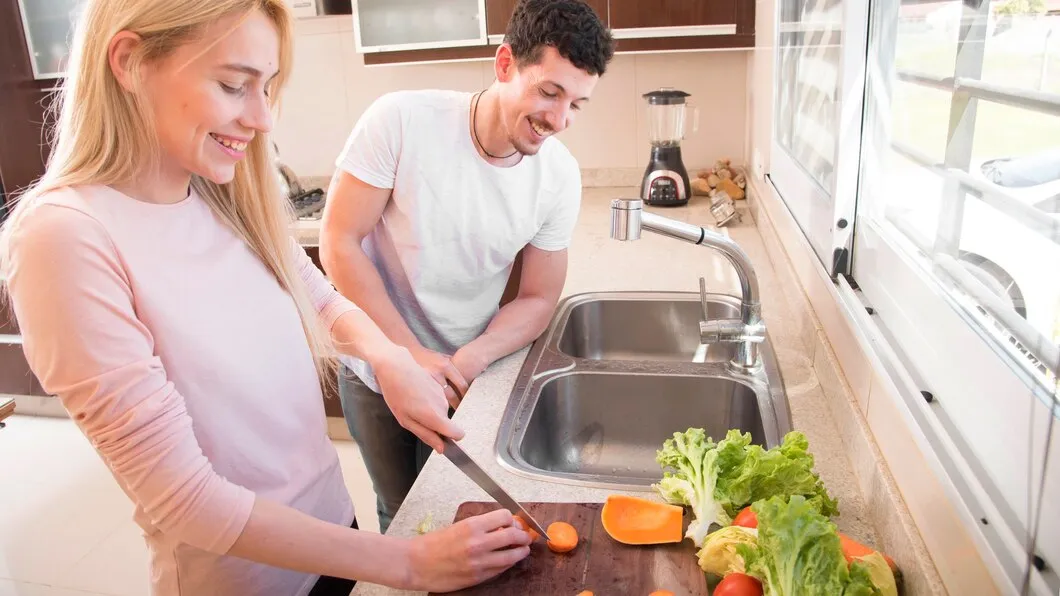 Woman cutting vegetables in kitchen