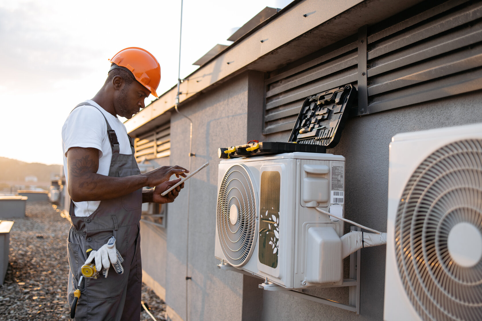 HVAC technician inspecting outdoor unit