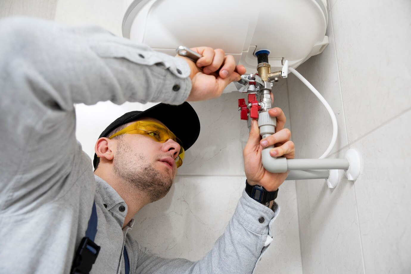 Plumber working on water heater connection