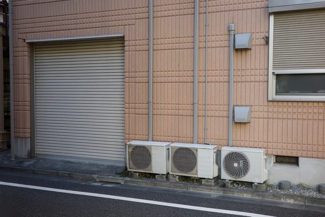 Three outdoor AC units outside building.