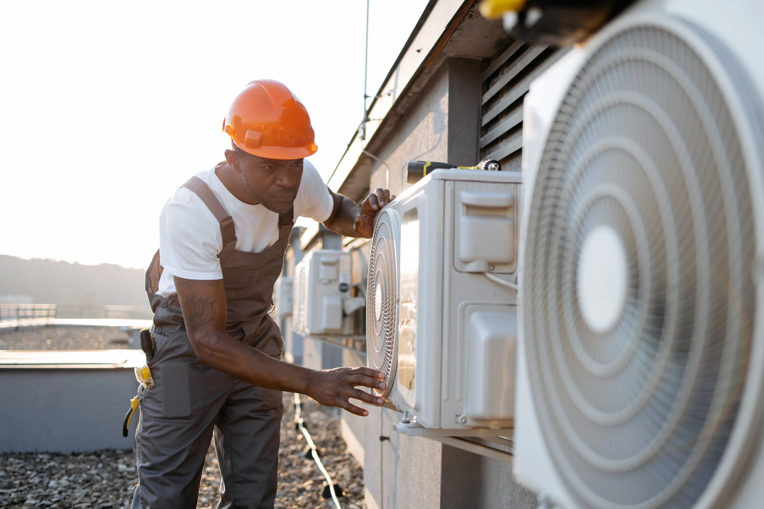 HVAC technician inspecting outdoor unit.