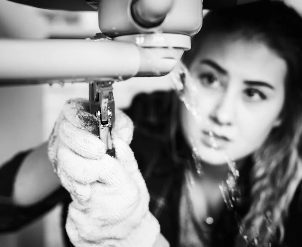 Person in gloves operating a professional tool or machine