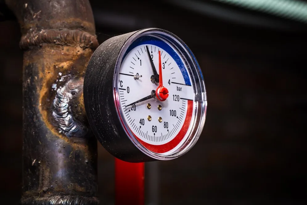 Water pressure gauge on pipe.