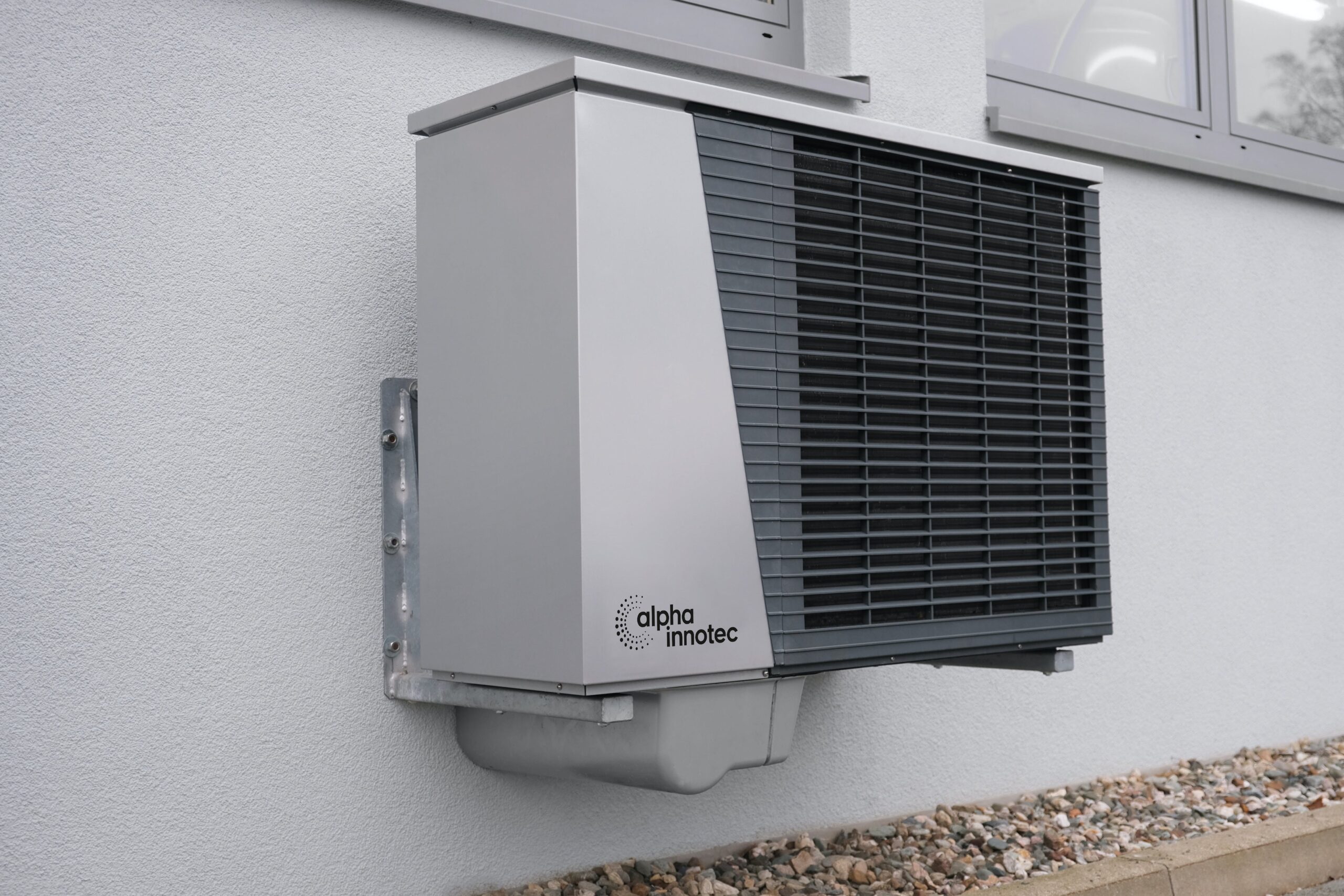 Alpha Innotec outdoor unit on wall.