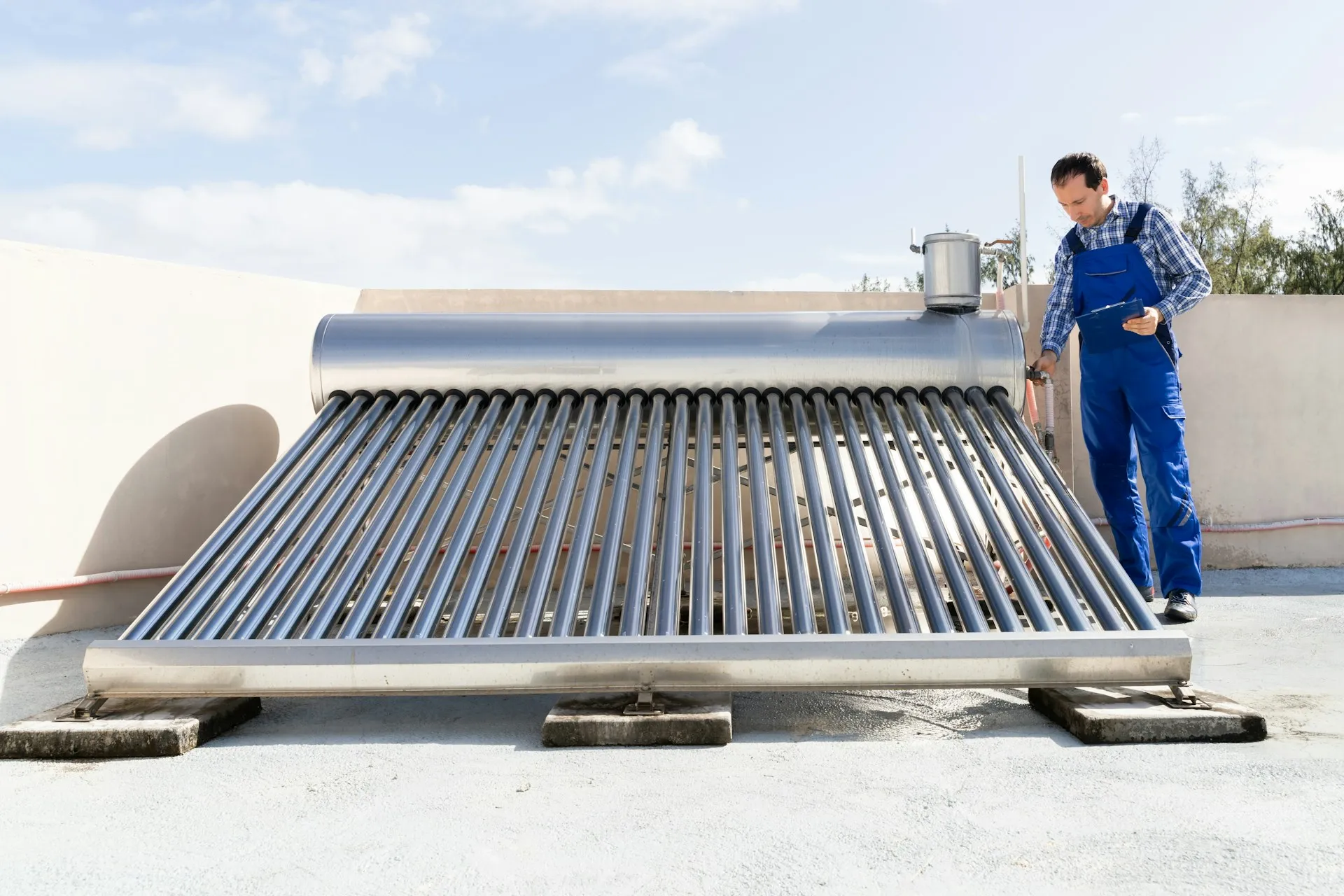Man working on a solar water heater.
