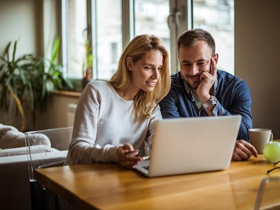 Couple looking at a laptop.