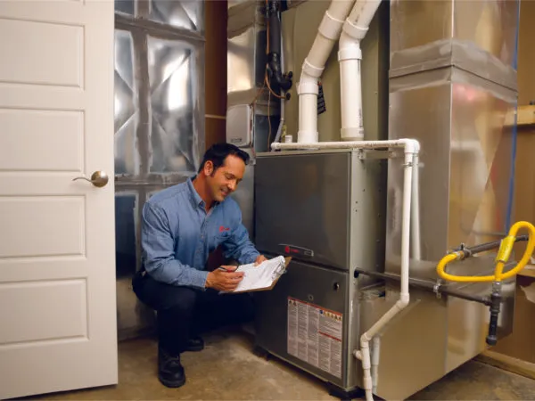 Man inspecting a furnace.