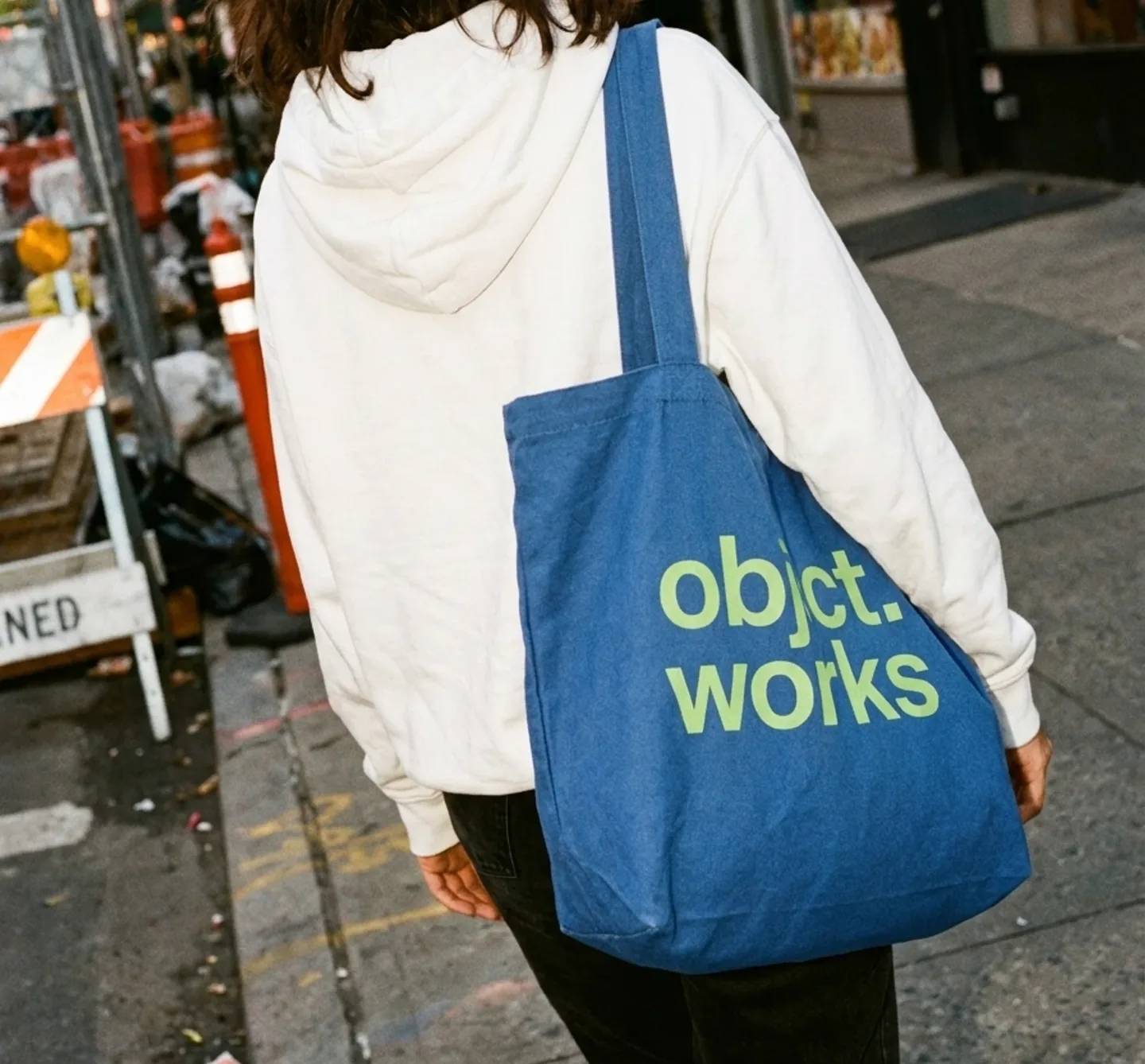 Person carrying a blue objct.works tote bag