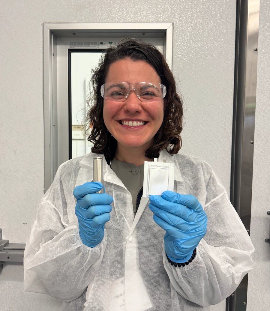 Dr. Alyssa Stavola in the Battery Innovation Center lab holding a cylindrical cell and a pouch cell