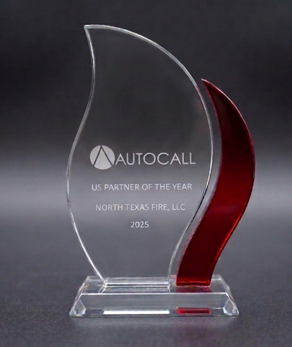 Clear and red flame-shaped AUTOCALL US Partner of the Year 2025 award for North Texas Fire, LLC.