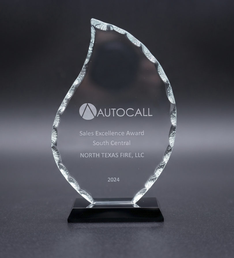 Clear glass award with jagged edges on a black base for Autocall Sales Excellence, 2024, North Texas Fire.