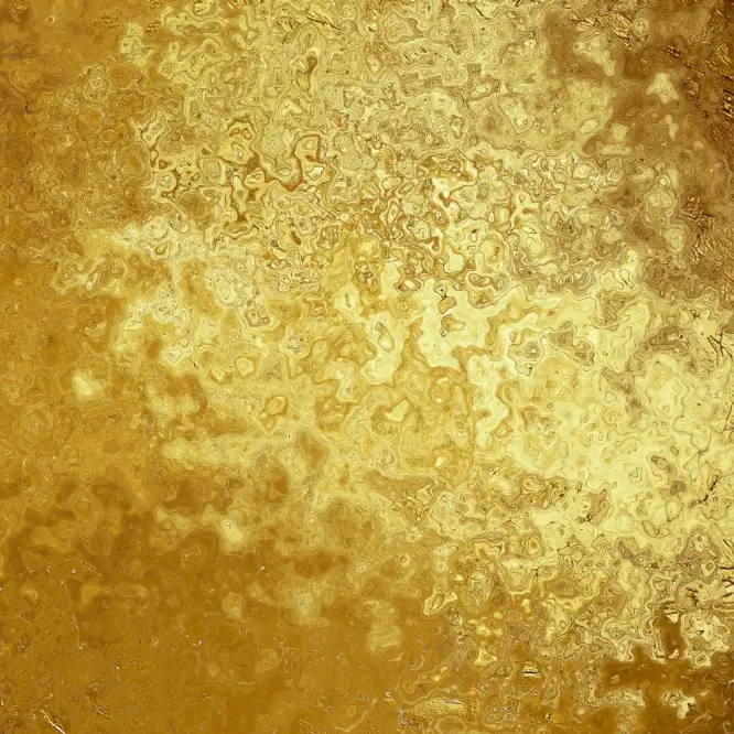 Close-up texture of a reflective gold surface with a wavy, irregular pattern and varying shades of gold and yellow.