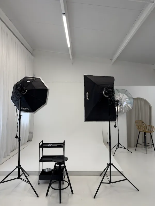 Godox octagon and rectangular softboxes, umbrella light and editor's trolley set up in front of the cyclorama