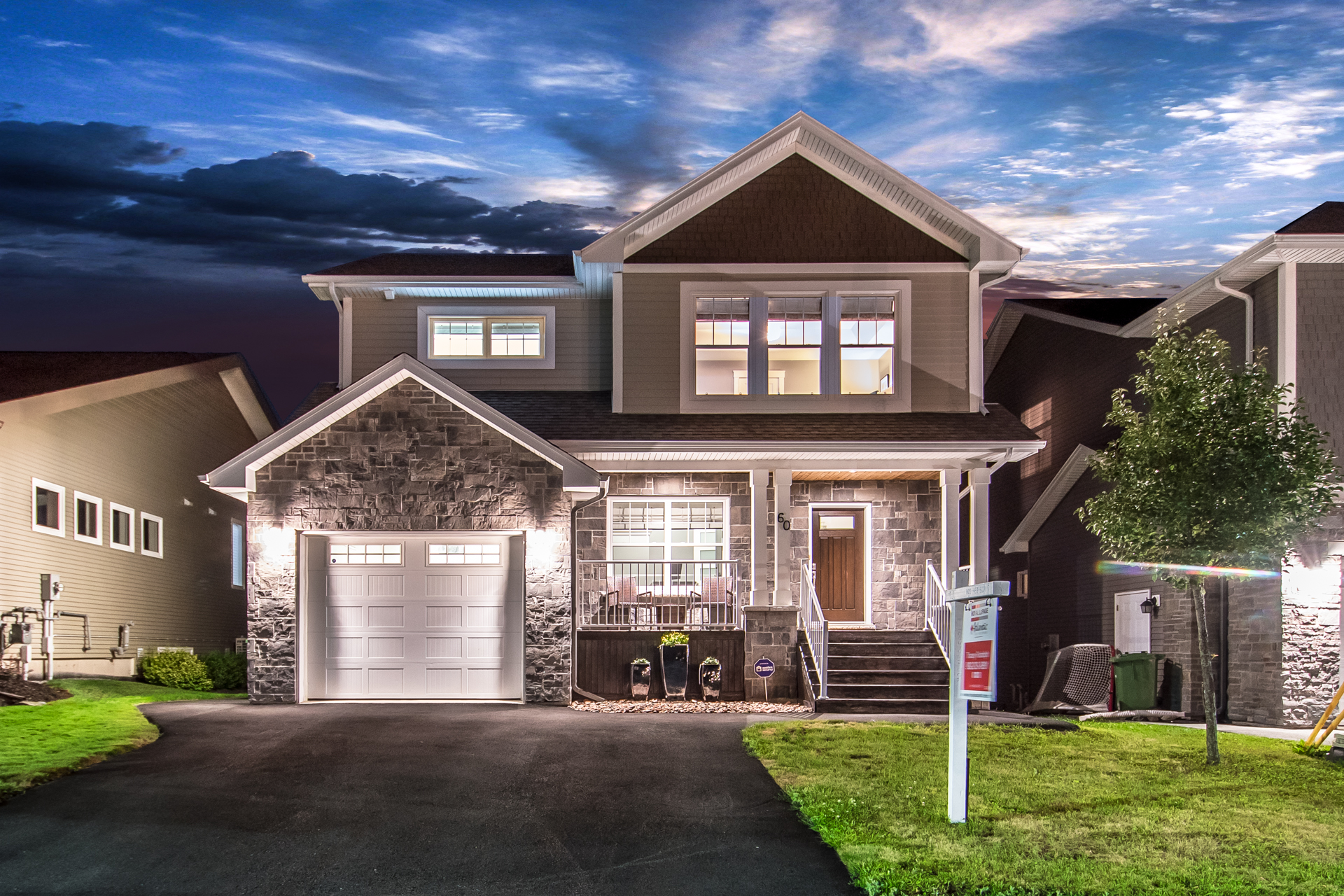 Two-storey stone-front home at twilight, real twilight photography by Newlife Studio, Halifax