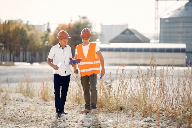 Engineers in hard hats outside a factory