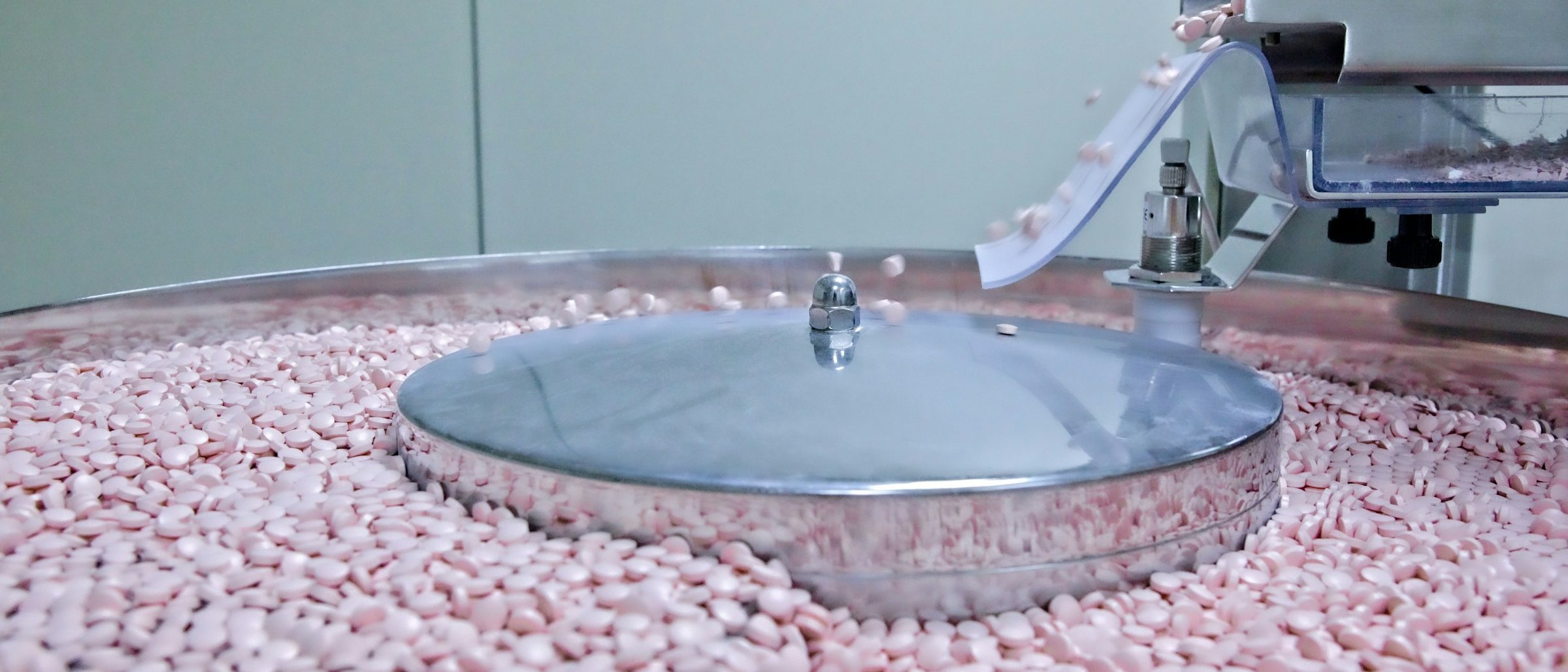 Tablets moving through a pharmaceutical production machine