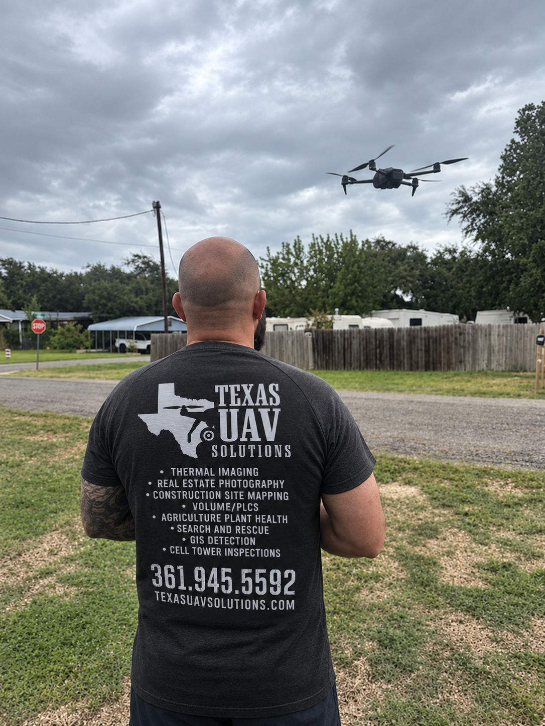 Dustin Hart operating a drone outdoors under a cloudy sky.