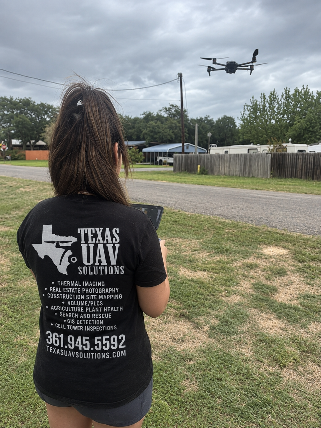 Felicia Hart operating a drone outdoors in a Texas UAV Solutions shirt.