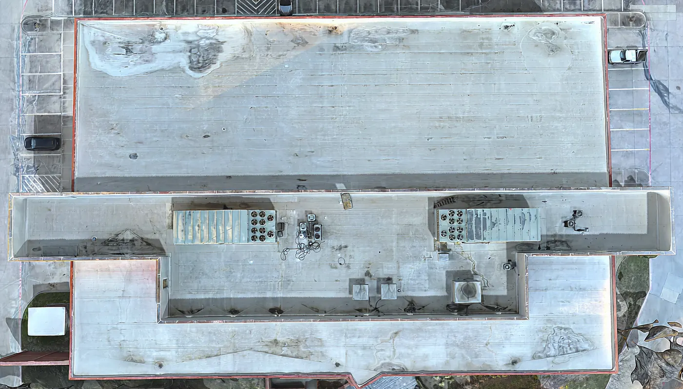 Drone photo of a large commercial flat roof with HVAC units