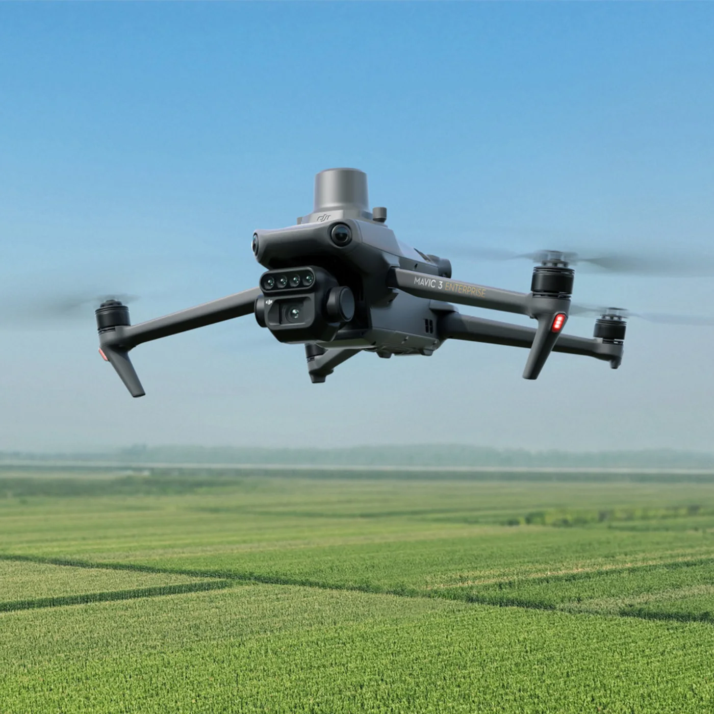 Multispectral drone flying over a green crop field