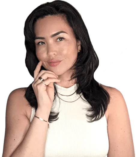 Coach Kate in a white top, resting her chin on her hand