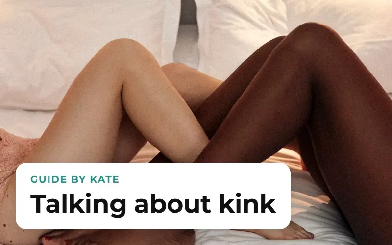 Two people's legs intertwined on a white bed