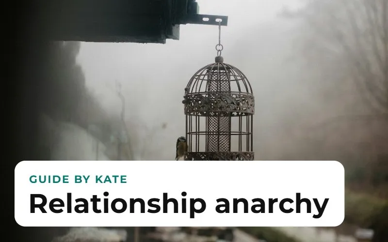 An ornate birdcage hanging outdoors in the mist