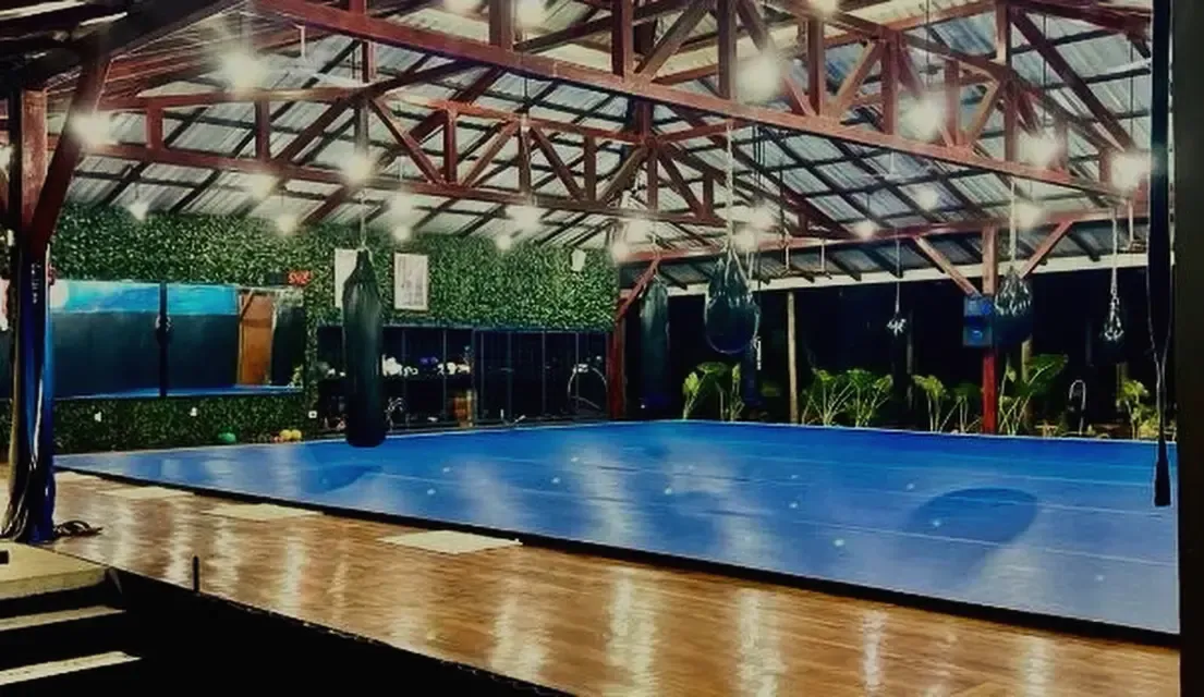 The open-air training gym at Jungle's Edge lit up at night
