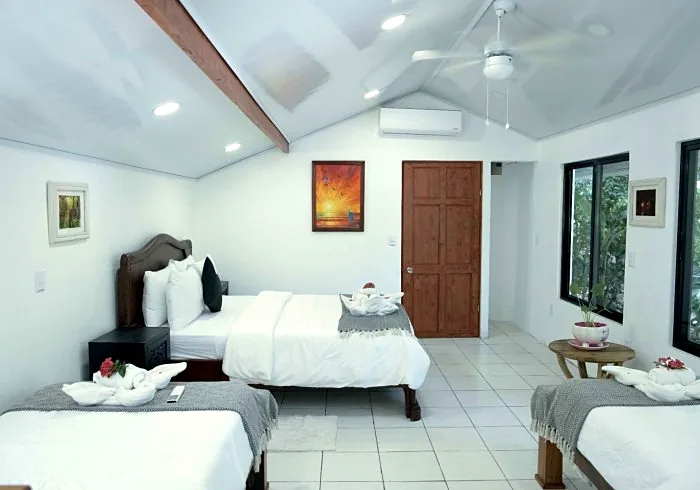Casita room with a queen bed and two single beds